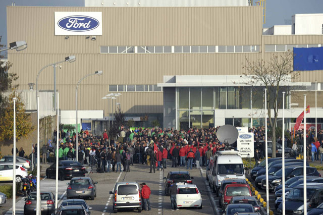 Workers at a Ford assembly plant gather during an emergency meeting with the plant management in Genk